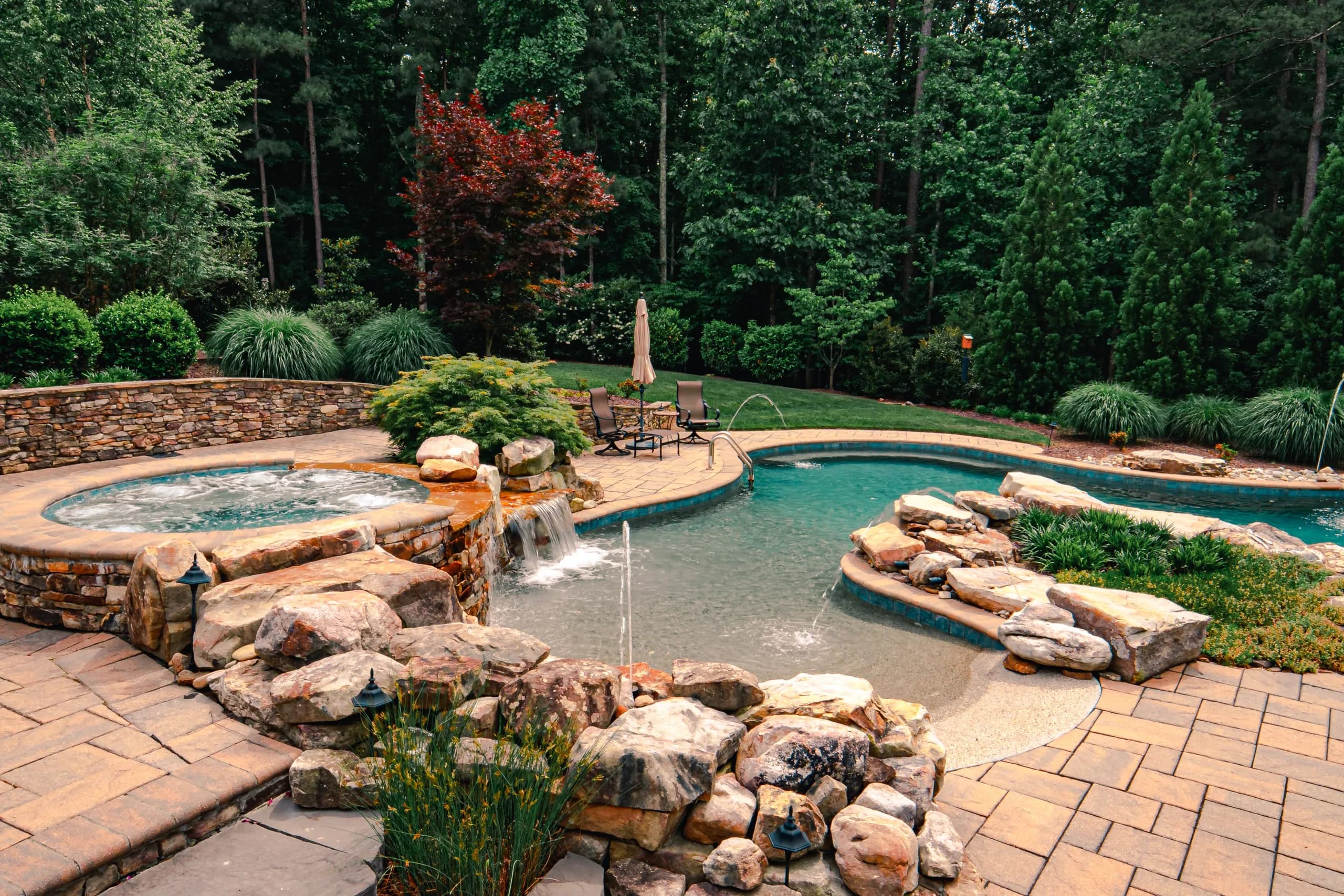 Sparkling blue inground swimming pool maintained by Platinum Pool Service